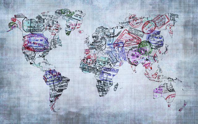 World map created with passport stamps, travel concept